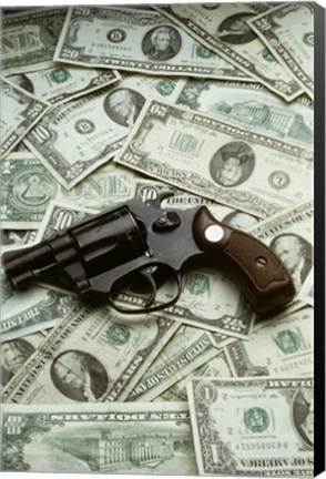 Framed Close-up of a handgun with paper currency Print