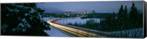 Framed Autumobile lights on busy street, distant city lights, frozen Westchester Lagoon, Anchorage, Alaska, USA. Print