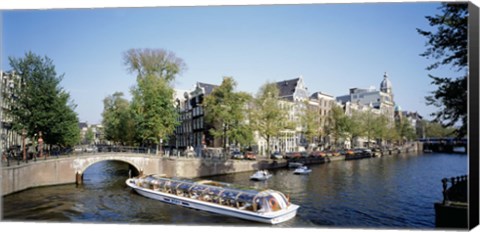 Framed Netherlands, Amsterdam, tour boat in channel Print