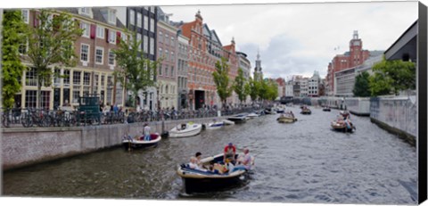 Framed Tourboats in a canal, Amsterdam, Netherlands Print