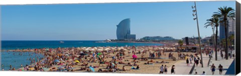 Framed Tourists on the beach with W Barcelona hotel in the background, Barceloneta Beach, Barcelona, Catalonia, Spain Print