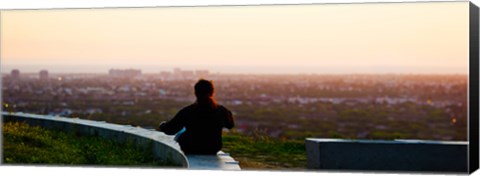 Framed Man sting on the ledge in Baldwin Hills Scenic Overlook Park, Culver City, Los Angeles County, California, USA Print