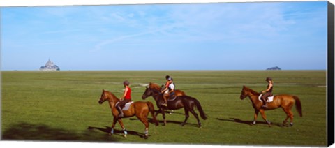 Framed Horseback riders in a field with Mont Saint-Michel island in background, Manche, Basse-Normandy, France Print