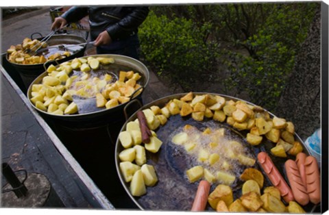 Framed Vendor selling deep fried potatoes and sausages at a sidewalk food stall, Old Town, Dali, Yunnan Province, China Print