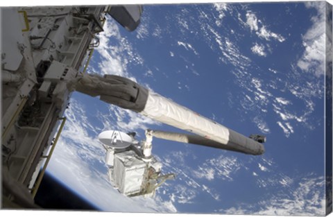 Framed Integrated Cargo Carrier in the grasp of the shuttle&#39;s remote manipulator system arm Print