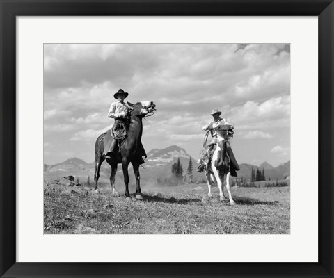 Framed Pair Of Cowboys On Horseback At Glacier Fifty Mountain Camp Print