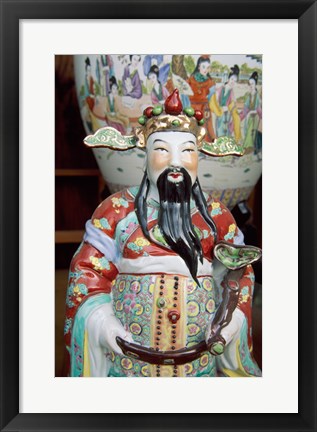 Framed Statue of a snake charmer holding a snake Print