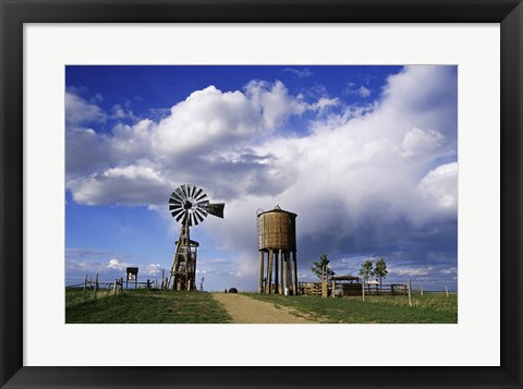 Framed Low angle view of a water tower and an industrial windmill, 1880 Town, South Dakota, USA Print