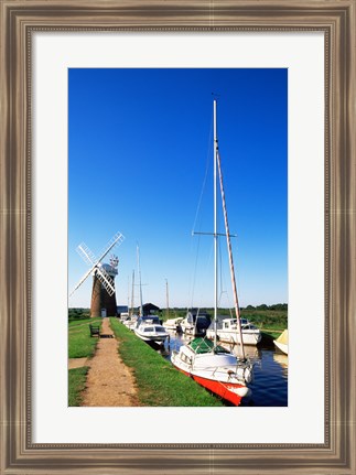 Framed Boats moored near a traditional windmill, Horsey Windpump, Horsey, Norfolk Broads, Norfolk, England Print