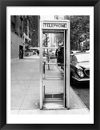 Framed Car parked at the side of a road near a telephone booth Print