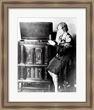 Framed Young woman sitting beside an RCA Radio-Phonograph and Home Recorder Print