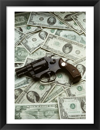 Framed Close-up of a handgun with paper currency Print