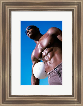 Framed Low angle view of a young man holding a volleyball Print