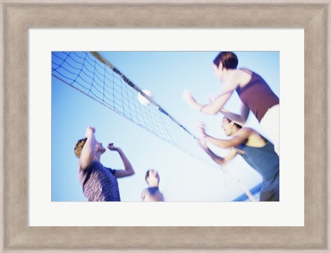 Framed Low angle view of two young couples playing beach volleyball Print