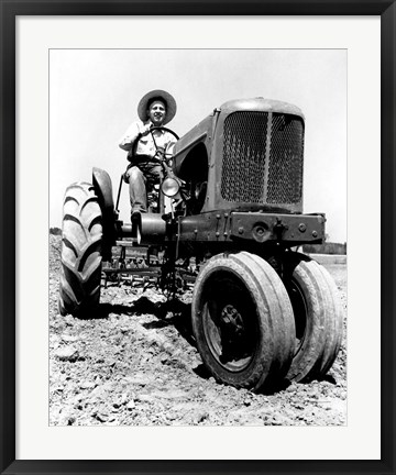 Framed Farmer Sitting on a Tractor in a Field Print