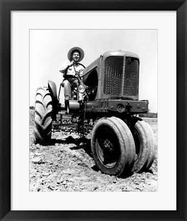 Framed Farmer Sitting on a Tractor in a Field Print