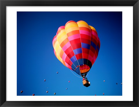 Framed Lone Hot Air Balloon with Other Hot Air Balloons in the Distance Print