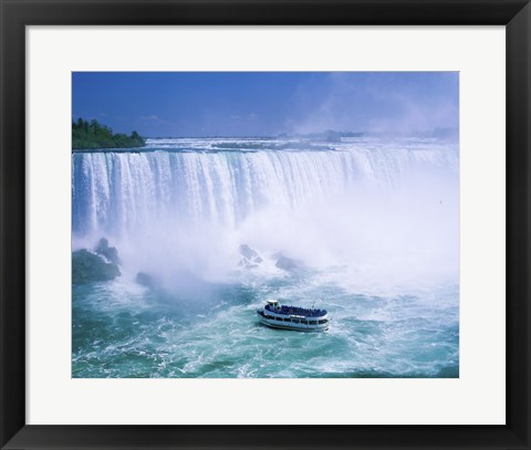 Framed High angle view of a tourboat in front of a waterfall, Niagara Falls, Ontario, Canada Print