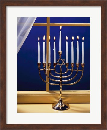 Framed Close-up of burning candles on a menorah at a window Print