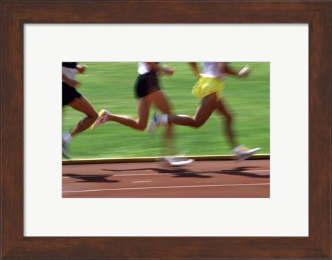 Framed Low section view of male athletes running on a running track Print