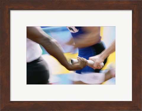 Framed Mid section view of runners exchanging baton at a relay race Print