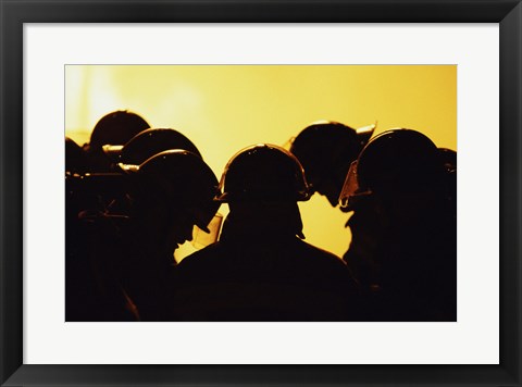 Framed Rear view of a group of firefighters looking down Print