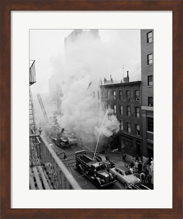 Framed New York City, Fire on East 47th Street, with fire engines shooting water on burning building Print