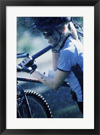 Framed Young woman carrying a bicycle on her shoulders Print