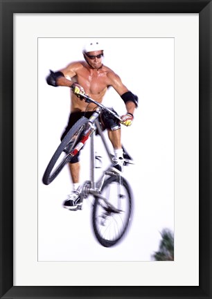 Framed Young man on a bicycle in mid-air Print