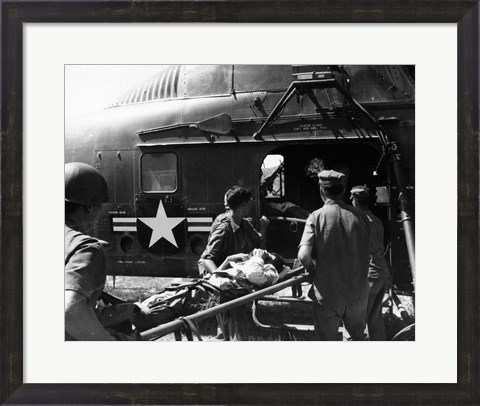 Framed Army soldiers carrying an injured person in a helicopter Print