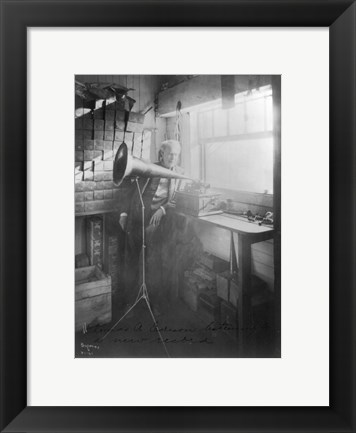 Framed Thomas Alva Edison, full-length portrait, standing, facing right, listening to a new record Print