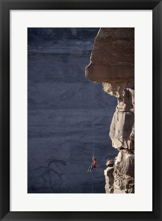 Framed Man hanging from a rope on the edge of a cliff Print