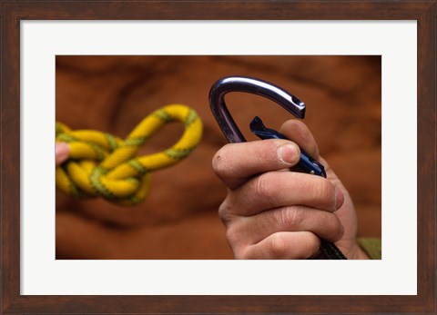 Framed Close-up of human hands holding a carabiner and rope Print