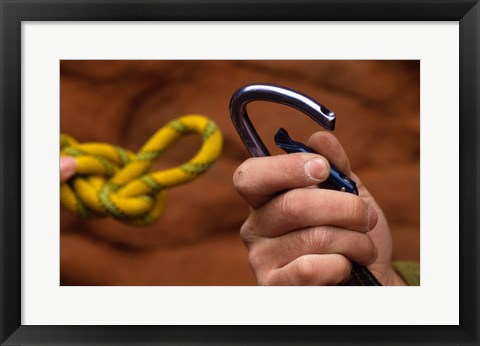 Framed Close-up of human hands holding a carabiner and rope Print