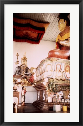 Framed Young Girl Praying in Front of a Giant Buddha Statue Print