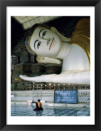 Framed Monk Sitting in Front of a Buddha Statue Print