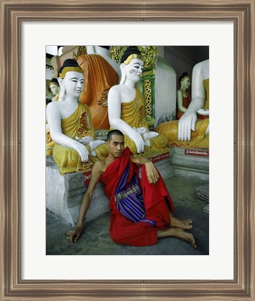 Framed Monk Sitting in Front of a Buddha Statue Print