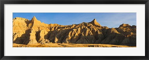 Framed Sculpted sandstone spires in golden light, Saddle Pass Trail, Badlands National Park, South Dakota, USA Print