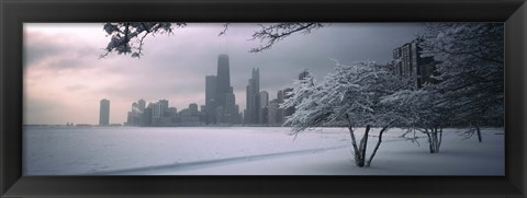 Framed Snow covered tree on the beach with a city in the background, North Avenue Beach, Chicago, Illinois, USA Print