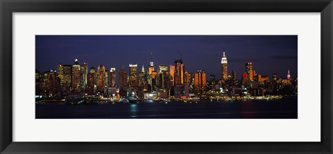 Framed Skyscrapers lit up at night in a city, Manhattan, New York City, New York State, USA Print