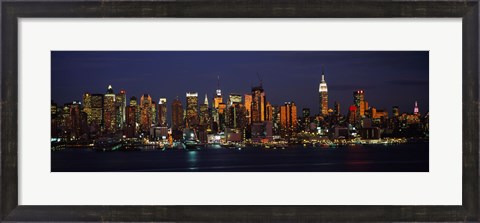 Framed Skyscrapers lit up at night in a city, Manhattan, New York City, New York State, USA Print