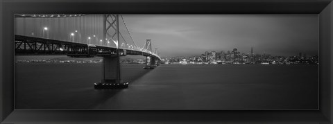 Framed Low angle view of a suspension bridge lit up at night, Bay Bridge, San Francisco, California, USA Print