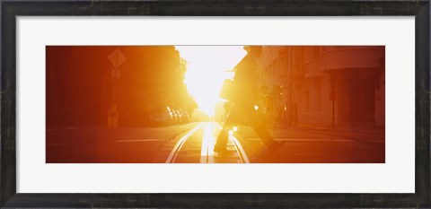 Framed Side profile of a person crossing the cable car tracks at sunset, San Francisco, California, USA Print