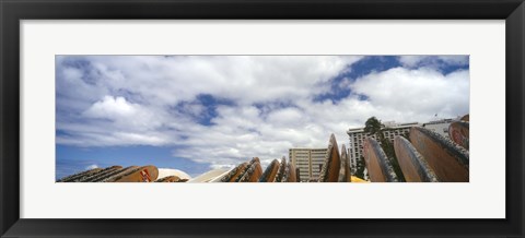 Framed Low angle view of skyscrapers and surfboards, Honolulu, Oahu, Hawaii, USA Print