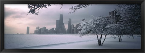 Framed Snow covered tree on the beach with a city in the background, North Avenue Beach, Chicago, Illinois, USA Print