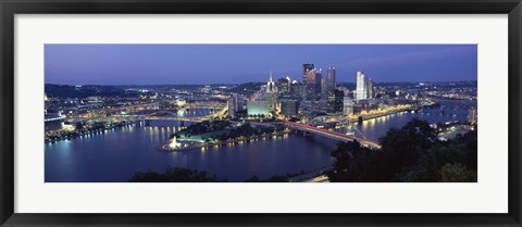 Framed Buildings along a river lit up at dusk, Monongahela River, Pittsburgh, Allegheny County, Pennsylvania, USA Print