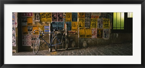 Framed Bicycle leaning against a wall with posters in an alley, Post Alley, Seattle, Washington State, USA Print