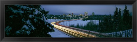 Framed Autumobile lights on busy street, distant city lights, frozen Westchester Lagoon, Anchorage, Alaska, USA. Print