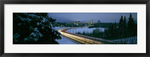 Framed Autumobile lights on busy street, distant city lights, frozen Westchester Lagoon, Anchorage, Alaska, USA. Print