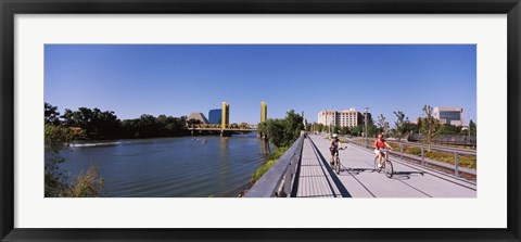 Framed Bicyclists along the Sacramento River with Tower Bridge in background, Sacramento, Sacramento County, California, USA Print